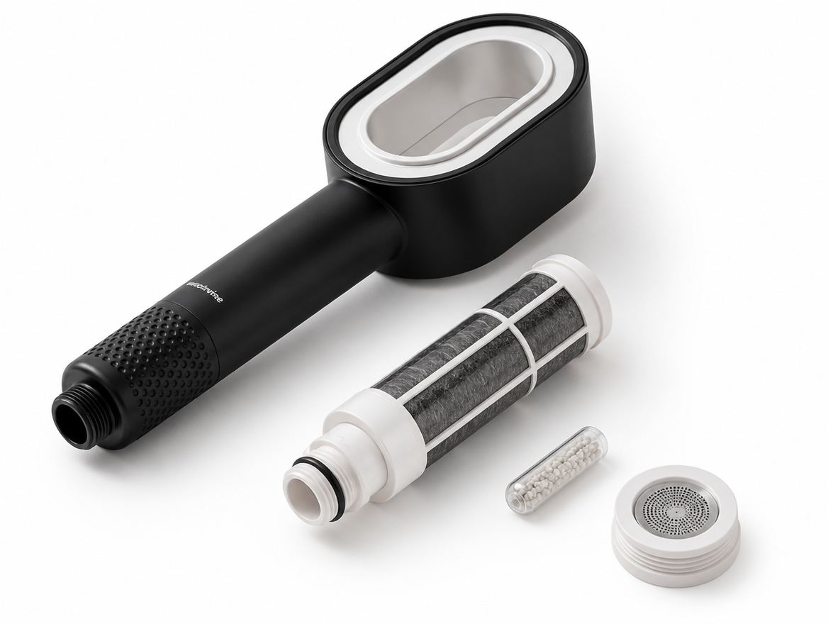 HYDRÉ showerhead body next to its removable carbon filter cartridge and vitamin C capsule